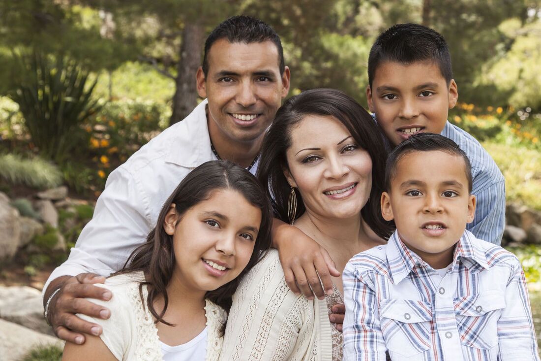 Photo of Latino family with mother, father, two boys and a girl.